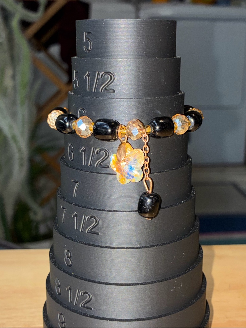 Black and Gold Beaded Stretch Bracelet with Iridescent Flower Charm - Picture 9 of 9